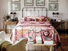 a bedroom with pink bedding and pictures on the wall