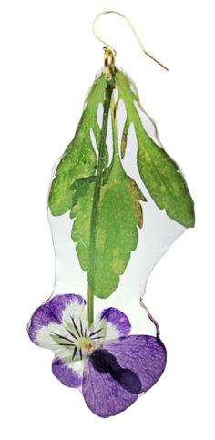 a glass ornament with a purple pansy flower hanging from it's side