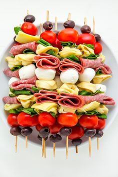 an appetizer is arranged on a plate with toothpicks and olives