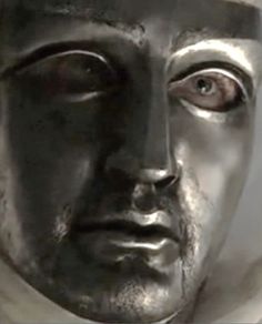 a close up of a statue with a man's face