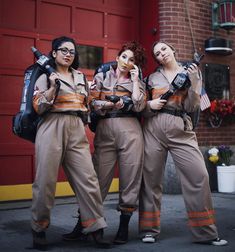 three women dressed in costumes standing next to each other