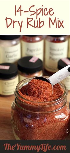 a jar filled with dry rub mix on top of a wooden table next to jars