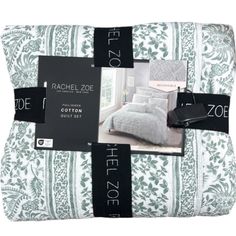 the bedding is white and green with black trimmings on it, along with two