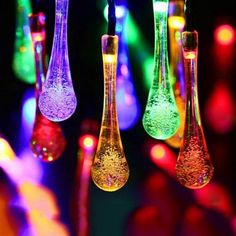 some colorful lights hanging from strings in the dark