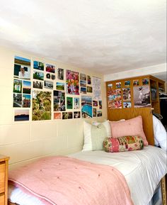 a bedroom with many pictures on the wall and a bed in front of a dresser