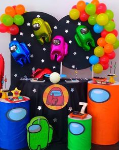 an assortment of colorful balloons and decorations on a table