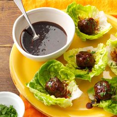 lettuce cups filled with meatballs and dipping sauce on a yellow platter