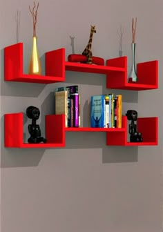 a red shelf filled with books next to a wall mounted giraffe figurine