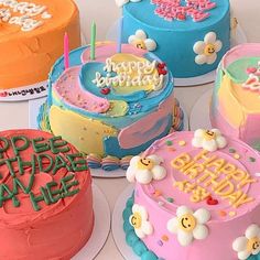 there are many colorful birthday cakes on the table with happy birthday messages written on them