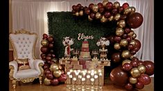 the dessert table is set up with gold and red balloons, champagne flutes, and cake