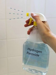 a hand holding a bottle with hydrogen peroxide on it