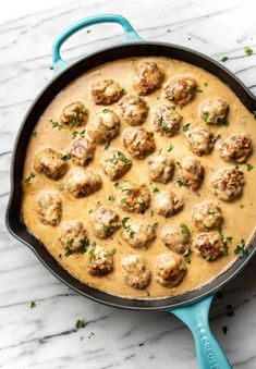 a skillet filled with meatballs and gravy