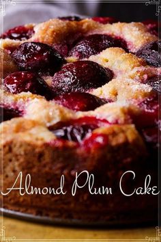 a close up of a cake on a plate with the words almond plum cake above it