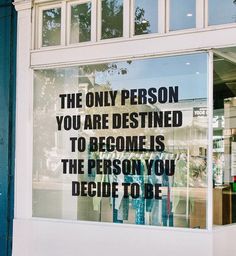 there is a sign in the window that says, the only person you are destined to become is the person you decide to be