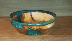 a wooden bowl sitting on top of a table