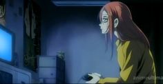 a woman with long red hair standing in front of a tv