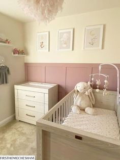 a baby's room with a crib, dressers and pictures on the wall