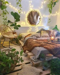 a bedroom with lots of plants and lights on the wall