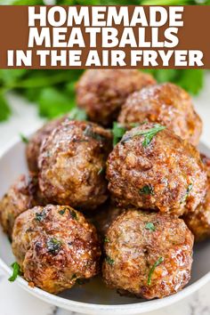 homemade meatballs in the air fryer on a white plate with parsley sprigs