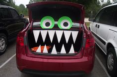 a car that has some fake teeth in it's back window and is decorated like a monster