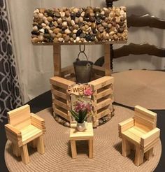 a table with chairs made out of wooden pallets and rocks on top of it