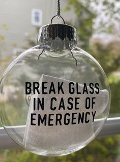 a glass ornament with a piece of paper taped to it that says break glass in case of emergency