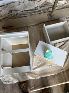 an open box sitting on top of a wooden floor next to other boxes and tools