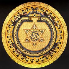 an intricately decorated plate with gold and black designs