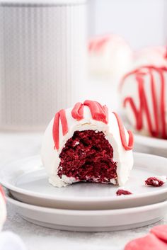 a red velvet cake with white frosting and sprinkles on a plate