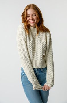 This cropped, shrunken turtleneck's textured detailing is perfectly complemented by the long ribbed cuffs and waistband. Throw it over your shoulders now and wear it alone later. COLOR: NATURAL FIT & MEASUREMENTS:  Length = 19 1/2" Measurements taken from size Small Hayley is wearing a size Small and is 5'8" FABRIC Textured Knit Cropped Sweater For Winter, Fitted White Cropped Sweater With Ribbed Cuffs, Cropped Textured Knit Sweater, Stretch Cropped Textured Knit Sweater, Stretch Cropped Sweater With Textured Knit, Stretch Textured Knit Cropped Sweater, Winter High Neck Cropped Sweater With Ribbed Cuffs, Cropped Winter Sweater With Ribbed Cuffs, Fitted Textured Knit Turtleneck Cropped Sweater