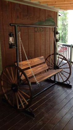 a wooden porch with a swing chair on it