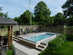 a hot tub sitting on top of a wooden deck