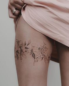 a woman's thigh with flowers on it