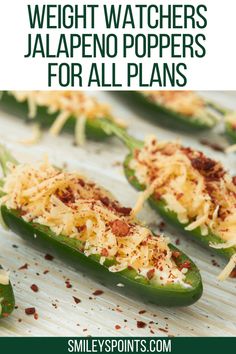 green peppers topped with cheese and other toppings on top of a baking sheet, text overlay reads weight watchers jalapeno poppers for all plans