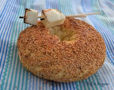 a bagel covered in sesame seeds with skewers sticking out of it