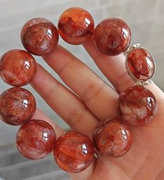 Material: Natural Red Hematoid Lepidocrocite Quartz beads  size :  21-22mm   quantity: one strand 6mm approx 29 pcs one strands 7mm approx25 pcs one strands 8mm approx 22 pcs one strands 9mm approx 21pcs one strands 10mm approx 19 pcs one strands 11mm approx 18pcs one strands 12mm approx 16 pcs one strands 13mm approx 16 pcs one strands 14mm approx 15 pcs one strands 15mm approx 14pcs one strands 16mm approx 14 pcs one strands 17mm approx 13pcs one strands 18mm approx 13pcs one strands 19mm appr Beaded Round Carnelian Bracelets, Beaded Round Carnelian Bracelet, Red Crystal Bracelet With Natural Stones, Red Natural Stones Crystal Bracelet, Handmade Carnelian Bracelet, Red Gemstone Beaded Bracelets With Round Beads, Bracelets With Large Beads, Beautiful Beaded Bracelet, Women Bracelet