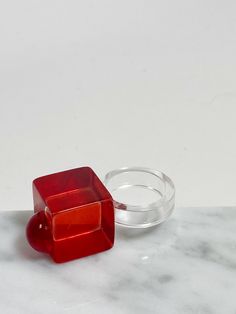 Vintage 1980's red and lucite acrylic ring. Size 8.5 Trendy Red Party Rings, Adjustable Vintage Ruby Ring, Vintage Adjustable Red Ruby Ring, Vintage Resin Rings For Gifts, Vintage Red Rings For Valentine's Day, Red Plastic Party Jewelry, Red Resin Ring Suitable For Gifts, Red Resin Rings Suitable For Gifts, Vintage Red Ruby Ring For Valentine's Day