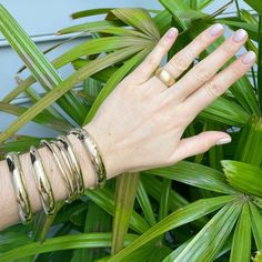 An adult-size polished 14K yellow gold-filled signet bangle bracelet featuring a diagonal space for personalization flanked by floral engraving. The outer shell is solid gold pressure-bonded to an inner core of high-quality brass. Guard and hinge Width: 12 mm Circumference: 7" Floral Engraving, Inner Core, Circle Monogram, Jewel Box, Gold Polish, Hinged Bangle, Hand Engraving, Bangle Bracelet, Band Rings