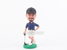 a custom bobble head with a golf player on it's face and holding a club