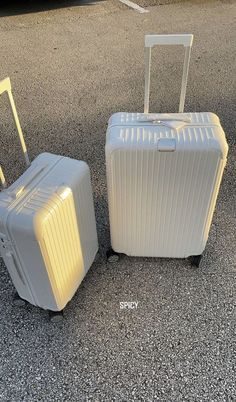 two suitcases sitting next to each other on the ground