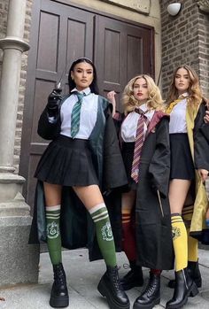 three young women dressed in harry potter costumes posing for a photo on the steps of a building