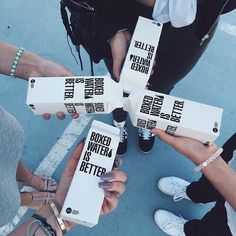 several people holding up boxes with writing on them