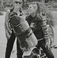 two women on a motorcycle posing for the camera