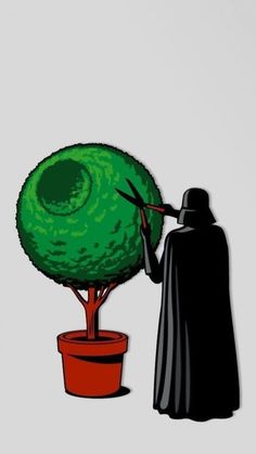 a person in a black cloak is painting a green tree with scissors and a potted plant