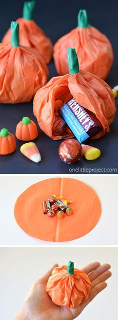 an orange bag filled with candy sitting on top of a table next to pumpkins