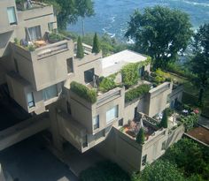 an aerial view of a building with trees on the roof