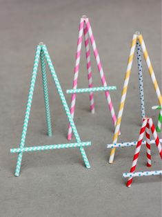 three paper straw easels sitting next to each other