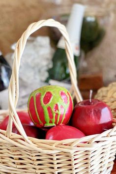 a basket filled with apples sitting on top of a table