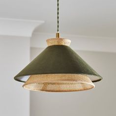 a green lamp hanging from a ceiling in a room