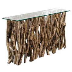 a glass and wood console table with driftwood design on the top, against a white background